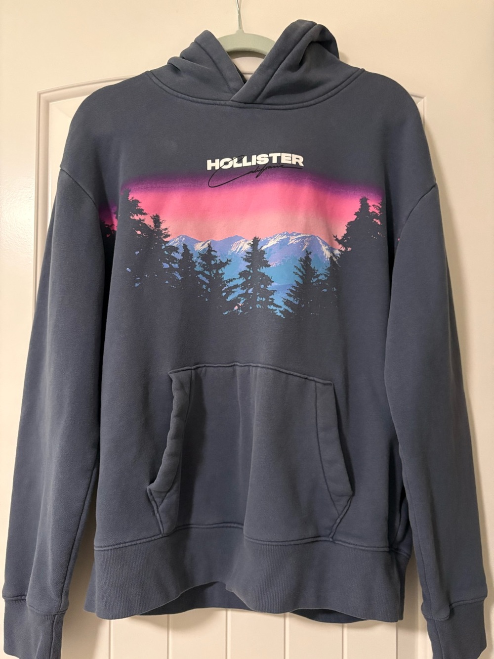 Hollister Men's Blue Crewneck Hoodie with Pink and Light Blue Sunset Graphic
